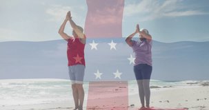 Animation of flag of dutch antilles over happy biracial couple meditating on beach. Lifestyle, sports, patriotism and wellbeing concept digitally generated video.