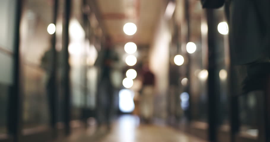 Blurred background, people and walking in the office, business or workplaace with professional employees or staff. Company, lobby and workers moving in the hall, corridor and hallway in agency