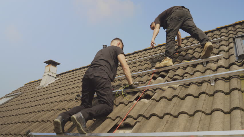 MS LA Technicians installing solar panel racks on roof | Shutterstock HD Video #1106933141