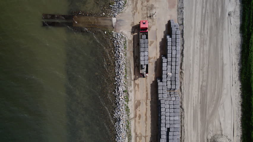 AERIAL MS Construction materials on Wadden Sea shore, Friesland, Netherlands | Shutterstock HD Video #1106933151