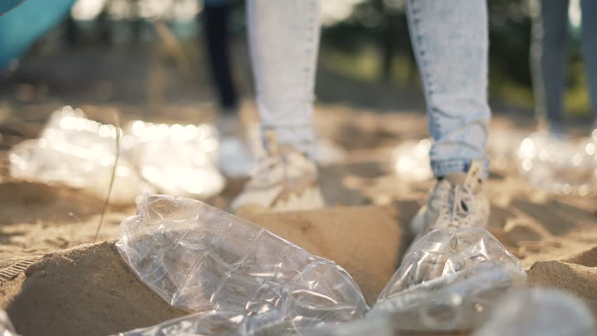 Teamwork.Cleaning plastic garbage in bag on beach in summer.Environmental pollution.Volunteer family clean up plastic waste garbage.Group of people are cleaning up waste garbage together.active people Royalty-Free Stock Footage #1106938339