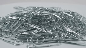 Metal rotating paper clips. Paper clips close up.