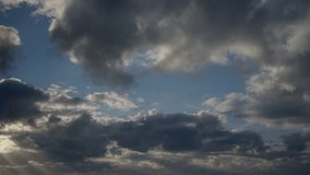 The morning blue sky is filled with fast cumulus clouds. Cloudy sky as background, timelapse video.