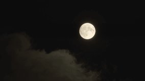 Full moon - supermoon moves through the night sky, accompanied by small clouds. - Powered by Shutterstock - Get 15% off with code: PIKWIZARD15