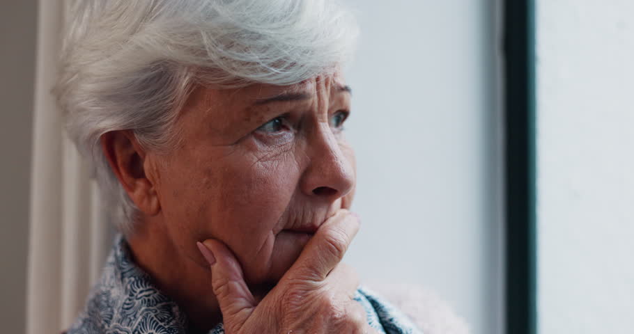 Senior woman, stress and face closeup with Alzheimer, doubt or grief in a retirement home. Elderly, female person and scared about dementia and mourning feeling confused with memory loss at window Royalty-Free Stock Footage #1106952241