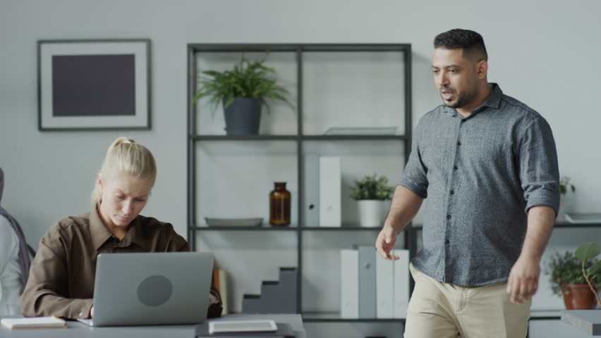 Medium shot of rude Middle Eastern man mistreating his Caucasian female subordinate at work in office Royalty-Free Stock Footage #1106952763