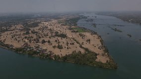 Aerial drone footage: Drone fly over Don Det Island forward to Mekong River and Don San Island, 4000 islands, Laos, 4K Drone, 