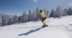 Experienced professional skier skiing on unprepared slope on a sunny winter day with fresh powder. Recorded at 120fps with cinema camera. Ski run 01 clip 5 of 6.