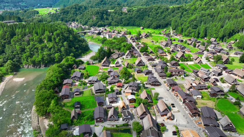 Shirakawago aerial view, traditional Japanese village in the Japanese Alps, idyllic houses with thatched roofs in a mountain valley in Japan, tourism in Japan. High quality 4k footage