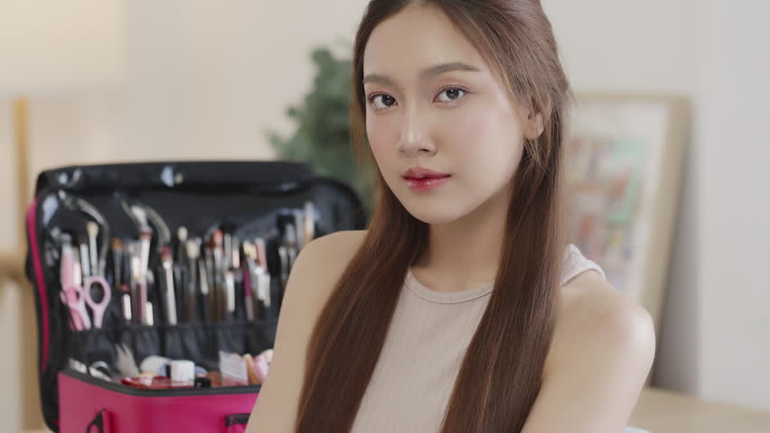 Beauty Asian woman with natural look make up lookin and smiling to camera.