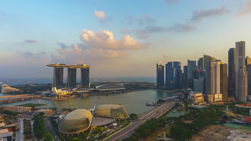 Singapore Sunset Beautiful Time lapse of day to night of Singapore city skyline from aerial and high angle overlooking Marina bay and CBD area. Tilt down motion timelapse, Prores 4KUHD Timelapse. Royalty-Free Stock Footage #1106960543