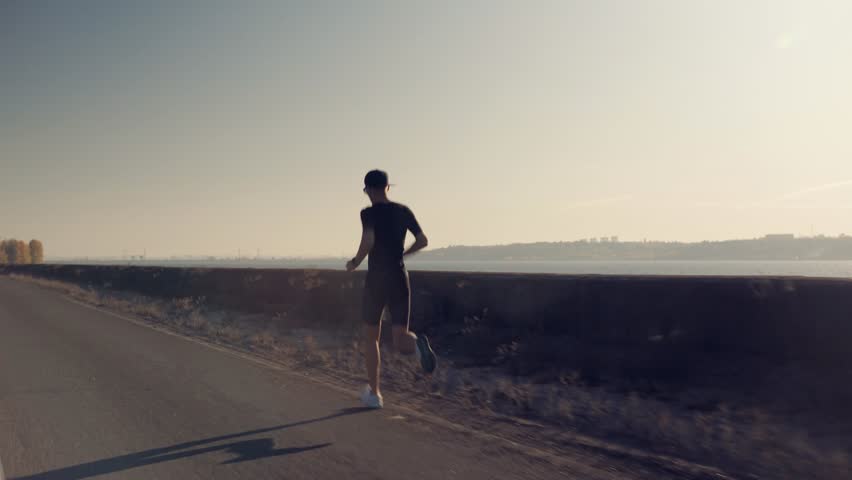 Runner Man Fit Athlete Legs Jogging On Road Sport Triathlon. Triathlete Running, Sprinting, Sport Endurance Marathon Workout. Running Man Healthy Lifestyle. Runner Jog Trail. Sport Recreation Fitness Royalty-Free Stock Footage #1106963005