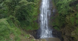 Drone: Surodipo Waterfall, Central Java. Beautiful natural landscapes in Indonesia's tourist destinations. Beautiful aerial drone video footage in the morning.