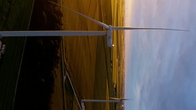 Aerial view of powerful Wind turbine farm for energy production. Aerial vertical, vertical video background.
