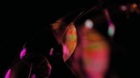 Colorful light refracting through soap bubble as they turn - abstract background layer