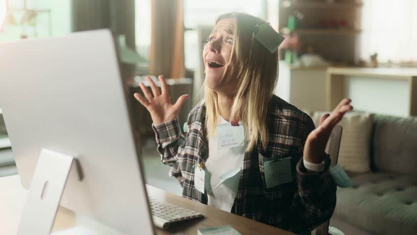 Nervous stressed blond mature woman freelancer with stickers typing quickly on computer and looking at papers asking to hurry up scream and warning about deadline at home workplace