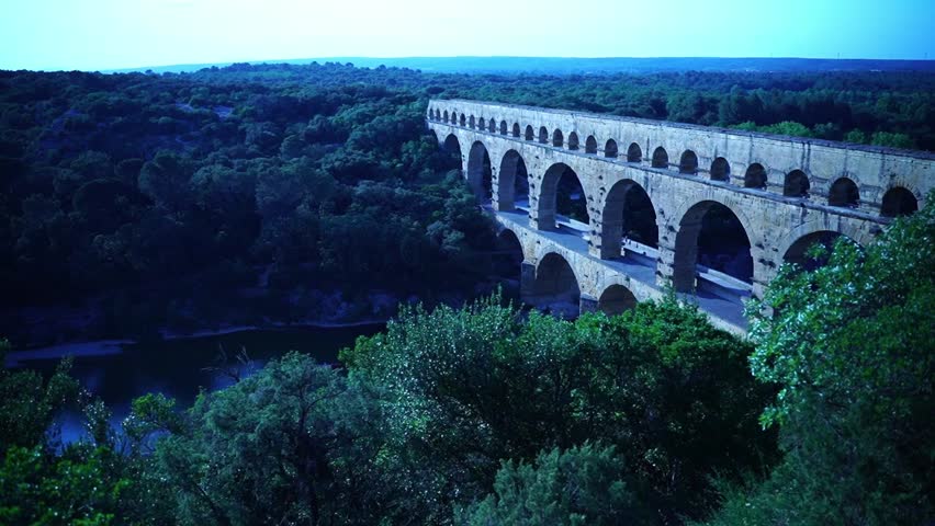 drone shot of old water pipe from the romans with stone arches over a river in france between nature in good weather