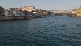Aerial view: Douro River, Dom Luis Bridge with seagulls at dusk. Porto, Portugal