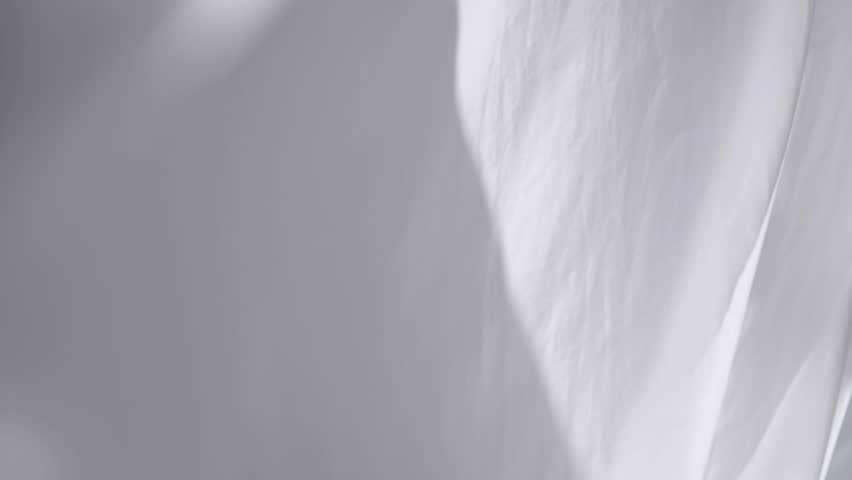 White transparent fabric flutters in the wind. Long white curtains in a bright studio. slow motion Royalty-Free Stock Footage #1106977967
