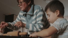 Grandmother and children cooking in the kitchen. Delicious food. - Powered by Shutterstock - Get 15% off with code: PIKWIZARD15