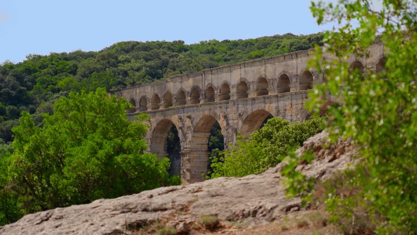Video shoot of Pont du Gard, a famous Roman Aqueduct on the Gardon River in France. Architecture and historical heritage concept.