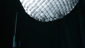 Studio light in a dark studio setting with a tripod
