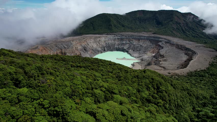 Beautiful aerial cinematic view of the Poas Volcano crater and lagoon in the National Park in Costa Rica