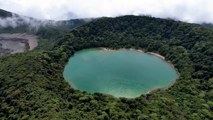 Beautiful aerial cinematic view of the Poas Volcano crater and lagoon in the National Park in Costa Rica