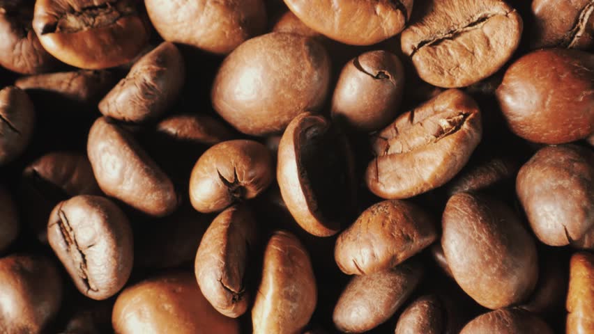 Сoffee Background. Coffee beans close-up. Roasted coffee beans spinning. Macro shot of seeds of coffee slow motion. Royalty-Free Stock Footage #1106994337
