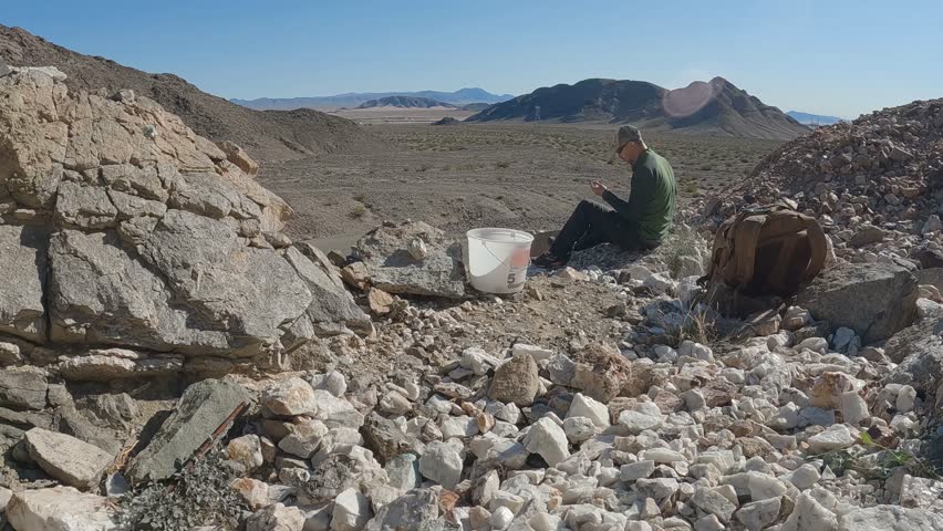 Man Rockhounding, Prospecting at Abandoned Mine in Desert