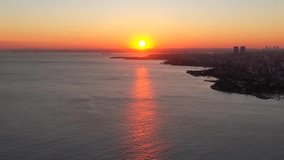 Scenic view of beautiful dramatic sunset over the Marmara Sea. Bostanci District offshore against the sun. Aerial view, Istanbul, Turkey
