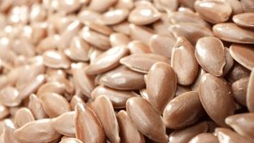 Flax seeds are commonly found in health food stores and are available in various forms, including whole seeds, ground (milled) seeds, flaxseed oil, and flaxseed meal. Grain background. Food concept
