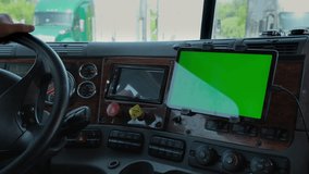 The driver in the truck holds a tablet with a green screen in his hands. Close up shot - Powered by Shutterstock - Get 15% off with code: PIKWIZARD15