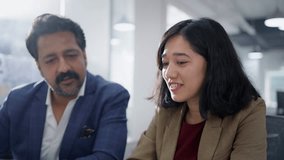 Close up of two happy modern Indian Asian female and male agents or coworkers of an insurance business company sitting busy discussing work together in a diverse corporate start up office workplace - Powered by Shutterstock - Get 15% off with code: PIKWIZARD15