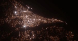 Wilmington (North Carolina, USA) top view at night. Aerial view on modern city from space. Camera is flying above the city, moving forward. Vertical video. The north is on the left side