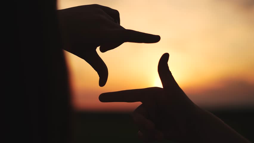 hands make camera from fingers at sunset. happy family kid dream concept. hands in the foreground fold the figure from the fingers. camera of fingers stacked in a field at sunset lifestyle Royalty-Free Stock Footage #1107007875