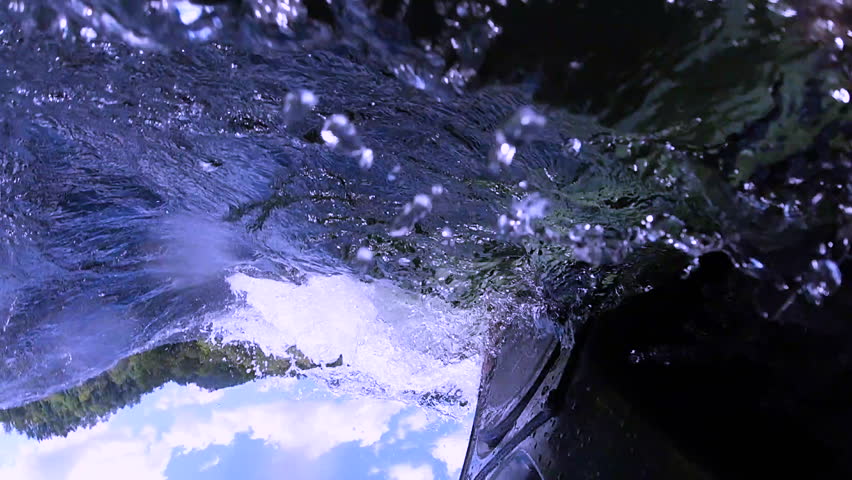 Slow motion POV kayak flips upside down in the river.