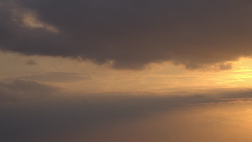 Evening clouds in orange sunlight. Summer season.