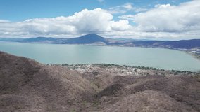 This compelling drone footage reveals a stunning aerial journey from the mountains to the vast, serene expanse of Lake Chapala in Jalisco, Mexico