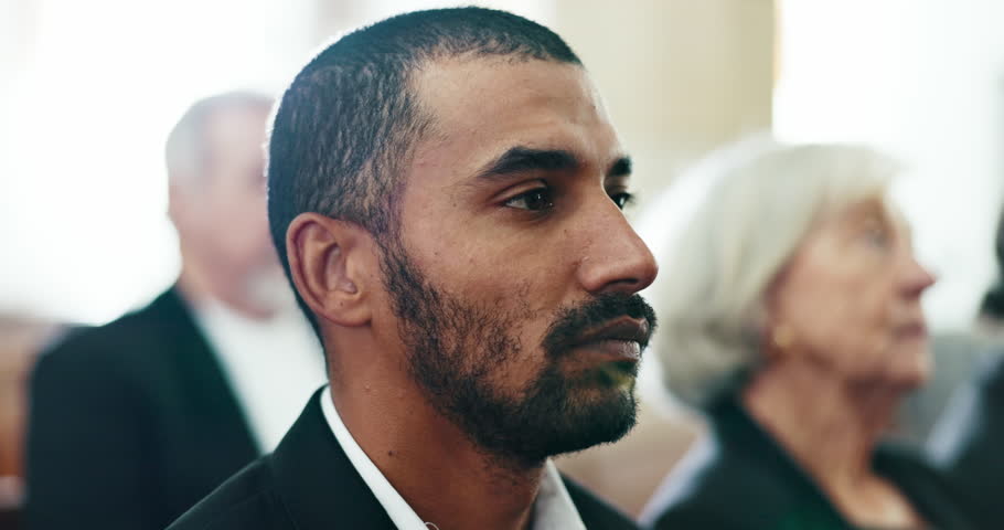 Sad, man and face closeup at a funeral in church for religious service and mourning. Grief, male person and burial with death, ceremony and grieving of chapel event of family member or friend