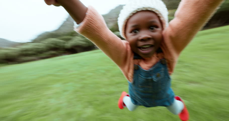 Child, play or hands of parent spinning in circle movement for quality bonding time in park. Family game, happy or pov of father swinging on grass lawn with an African kid, smile or freedom outdoors