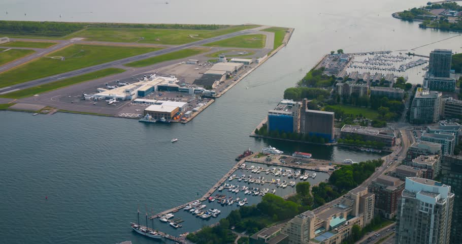 Top view from CN Tower of Inner Harbor Toronto, Canada. Slow motion video from top at Inner Harbor in Toronto. Enjoy cinematic view from top to Inner Harbor in Toronto before boarding plane in airport