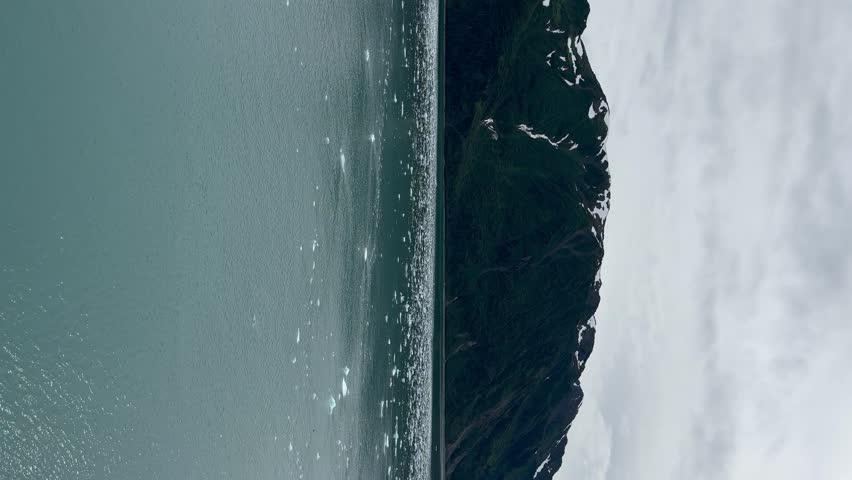 Ice floating near the coastline by Hubbard Glacier, Alaska - vertical orientation