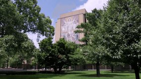 Hesbaugh Library, Touchdown Jesus, on the campus of Notre Dame University in South Bend, Indiana with gimbal video walking forward.