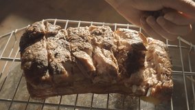 This video shows a hand putting brown sugar on top of tender smoked pork.