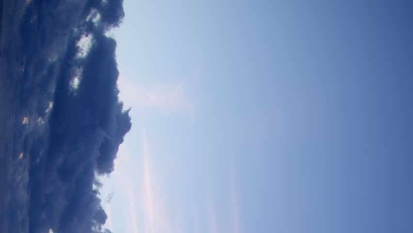 A video timelapse captures the gentle and calming beauty of the clouds in a peaceful and tranquil blue hour sky, creating a mesmerizing display of nature's beauty. Vertical video. Royalty-Free Stock Footage #1107028117