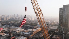 Drone Shot of The American Flag flying above New York City construction site - Powered by Shutterstock - Get 15% off with code: PIKWIZARD15