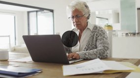 Animation of network of connections with icons over african american senior woman using laptop. Global connections, computing and data processing concept digitally generated video. - Powered by Shutterstock - Get 15% off with code: PIKWIZARD15