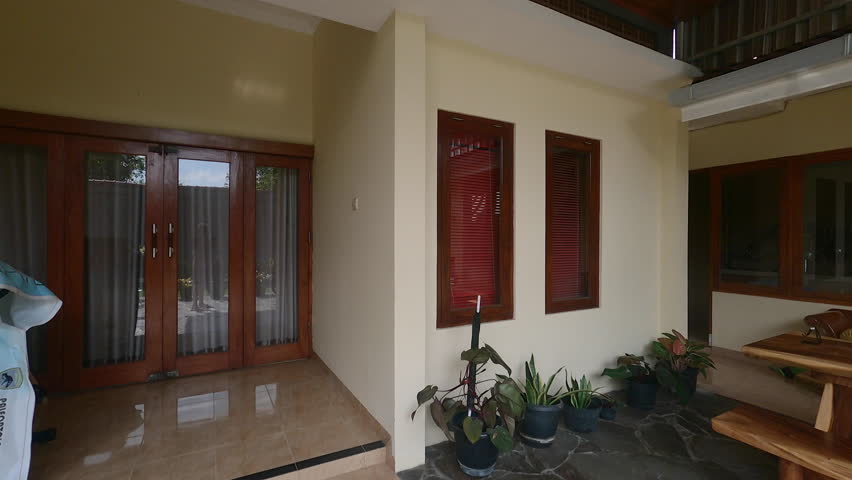 Panning shot left to right shot view of cozy outdoor sitting place with wooden furniture