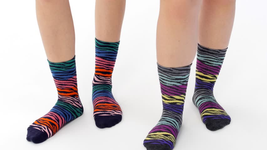Front and back view with multicolored socks. In the white studio, 2 female models are dancing happily with stockings while keeping the rhythm. Socks Catalog series. Digital printing. 